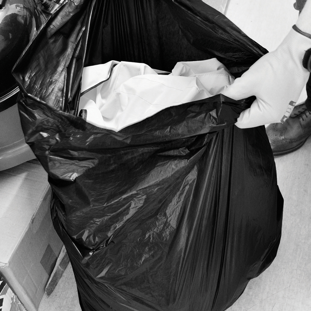 Refuse sack being filled with rubbish